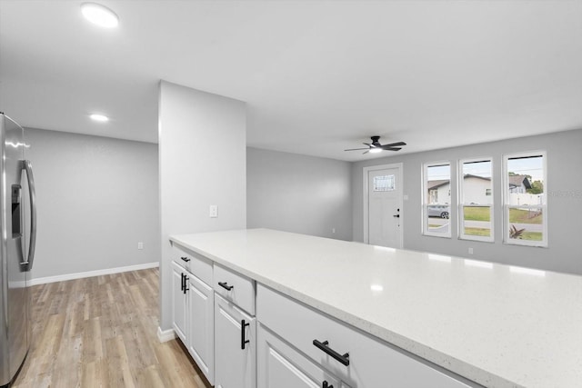 kitchen featuring ceiling fan, light hardwood / wood-style floors, white cabinetry, and stainless steel refrigerator with ice dispenser