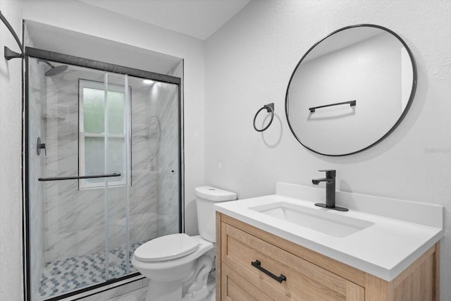 bathroom with a baseboard heating unit, vanity, toilet, and a shower with shower door