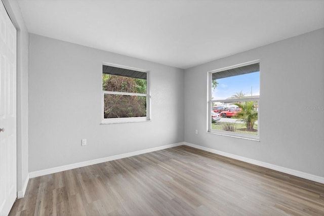 spare room featuring plenty of natural light and light hardwood / wood-style floors