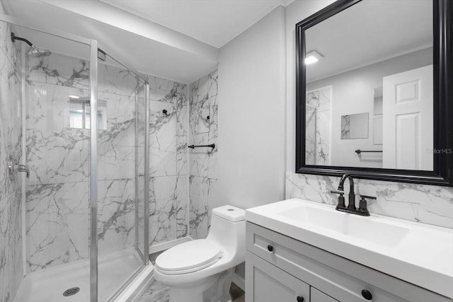 bathroom with a shower with door, vanity, and toilet