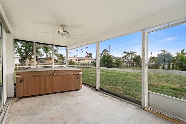 unfurnished sunroom featuring ceiling fan and plenty of natural light