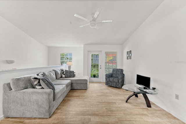 living room with ceiling fan and light hardwood / wood-style floors