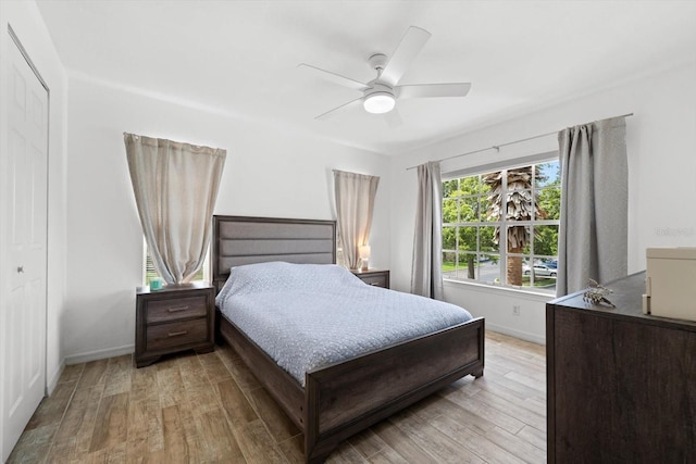 bedroom featuring hardwood / wood-style floors, a closet, and ceiling fan