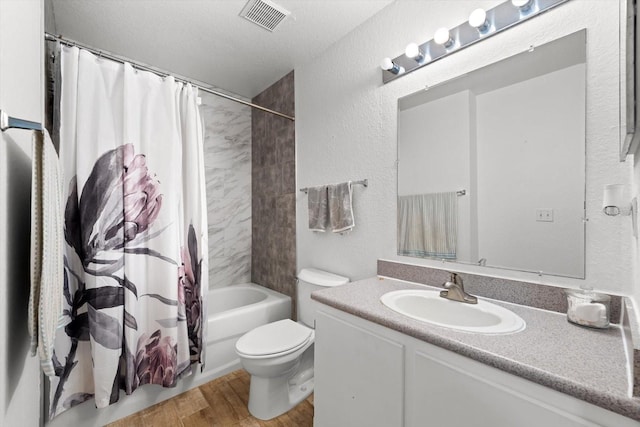 full bathroom featuring shower / bathtub combination with curtain, wood-type flooring, a textured ceiling, toilet, and vanity