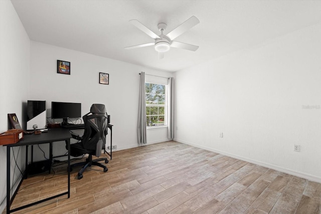 office space with light hardwood / wood-style flooring and ceiling fan