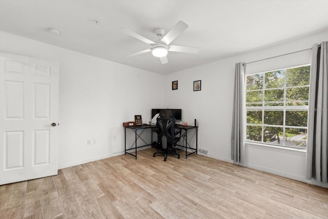 home office with ceiling fan and light wood-type flooring