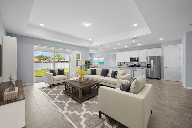 living room with a tray ceiling