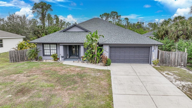 view of front of home with a garage and a front lawn