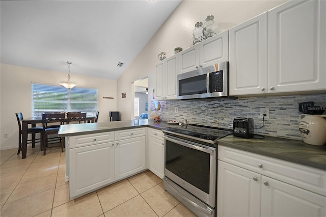 kitchen with kitchen peninsula, white cabinetry, stainless steel appliances, and lofted ceiling