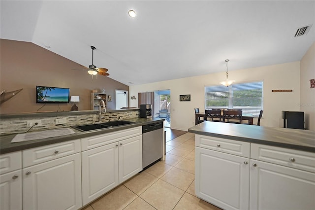 kitchen featuring tasteful backsplash, sink, dishwasher, white cabinetry, and hanging light fixtures