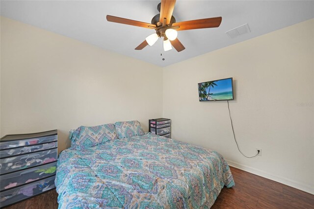 bedroom with ceiling fan and dark hardwood / wood-style flooring