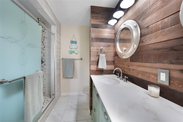 bathroom with wood walls, vanity, an enclosed shower, and toilet