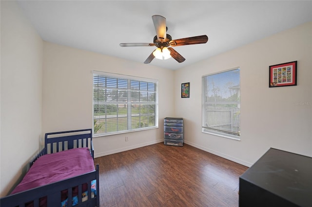 bedroom featuring dark hardwood / wood-style flooring and ceiling fan