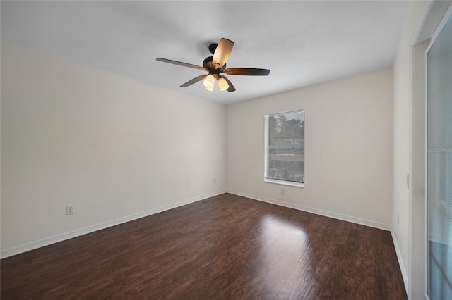 spare room featuring dark hardwood / wood-style floors and ceiling fan