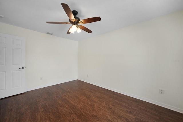 empty room with ceiling fan and dark wood-type flooring