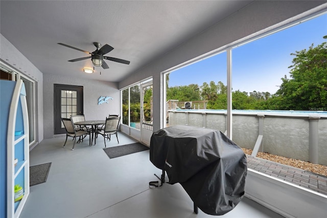 sunroom / solarium featuring ceiling fan