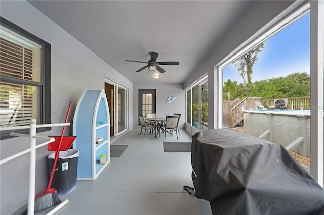 sunroom / solarium featuring ceiling fan and plenty of natural light