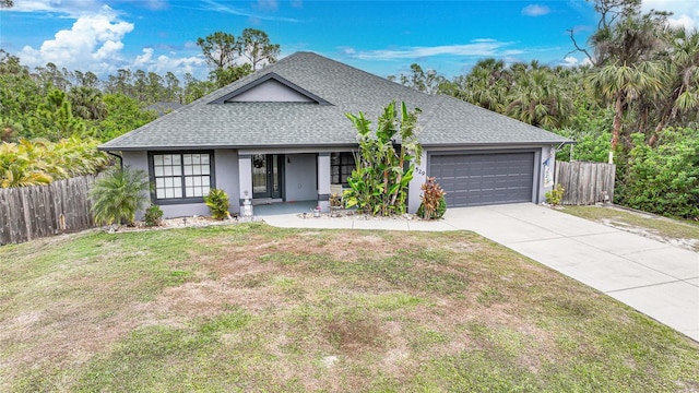 view of front of house featuring a front lawn and a garage