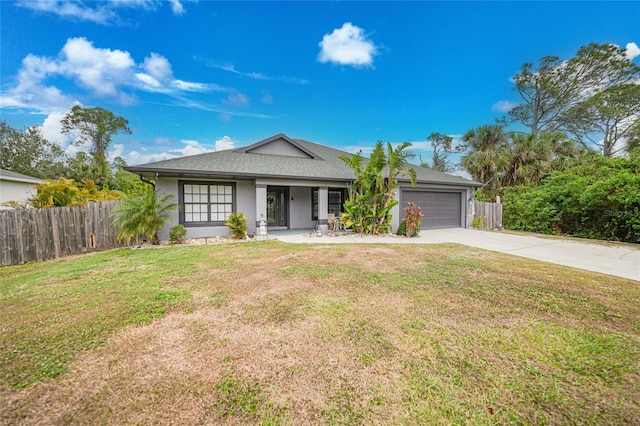 view of front of house with a front yard and a garage