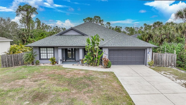 ranch-style house with a garage and a front lawn