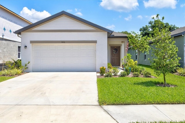 ranch-style house with a garage and a front lawn