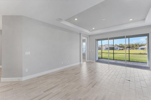 spare room with a raised ceiling