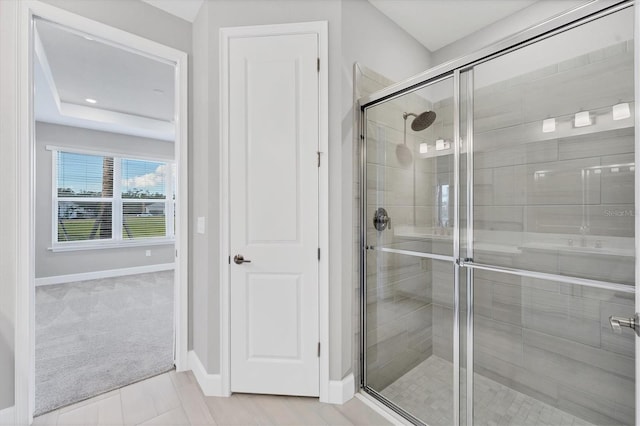 bathroom with tile patterned flooring and a shower with door