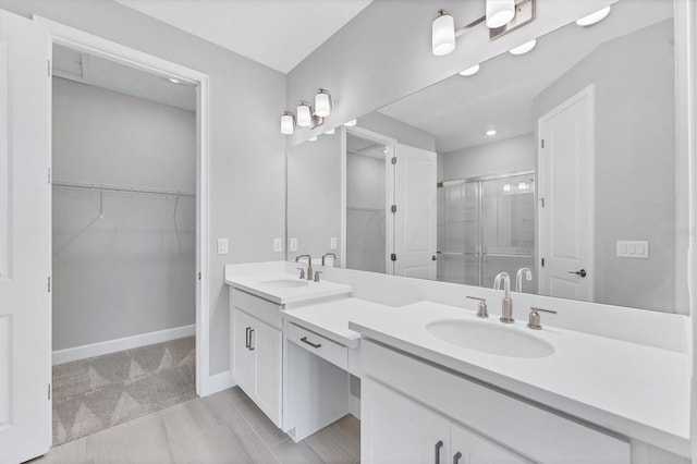 bathroom with vanity and an enclosed shower