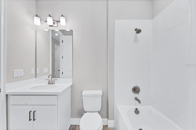 full bathroom featuring vanity, tiled shower / bath combo, and toilet