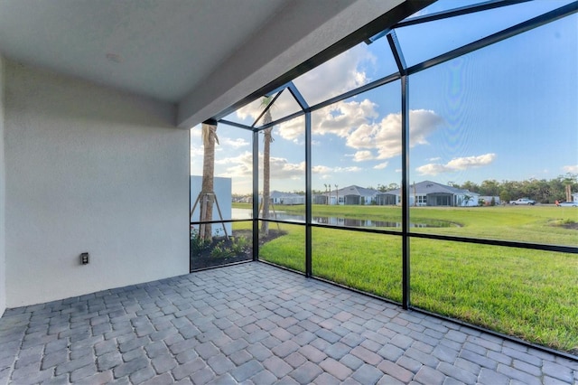 unfurnished sunroom featuring a healthy amount of sunlight and a water view