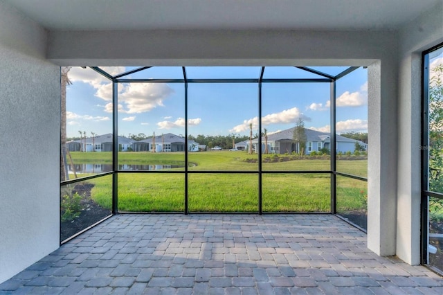 unfurnished sunroom with a water view