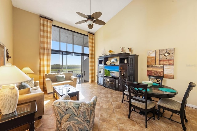 living room featuring ceiling fan and high vaulted ceiling