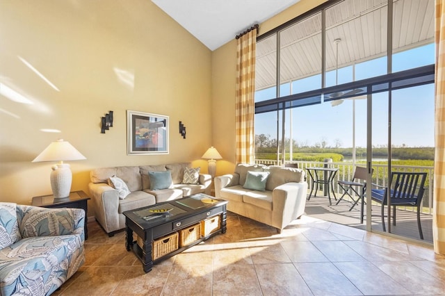 tiled living room featuring a rural view, high vaulted ceiling, and a healthy amount of sunlight