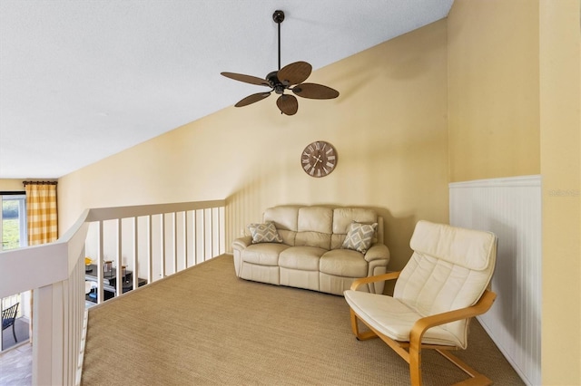 living area featuring ceiling fan and vaulted ceiling