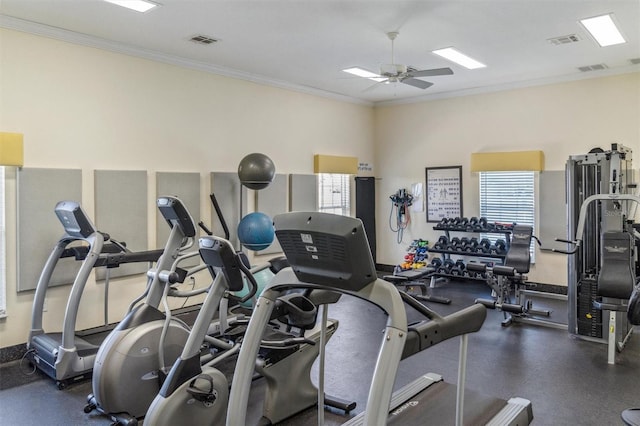 workout area featuring ceiling fan and ornamental molding