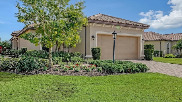 mediterranean / spanish-style home featuring a front lawn and a garage