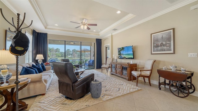 living room featuring a tray ceiling, ceiling fan, crown molding, and light tile patterned flooring