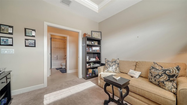 living room featuring light colored carpet, vaulted ceiling, and crown molding