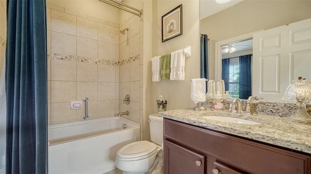 full bathroom featuring vanity, ceiling fan, toilet, and shower / bath combo with shower curtain