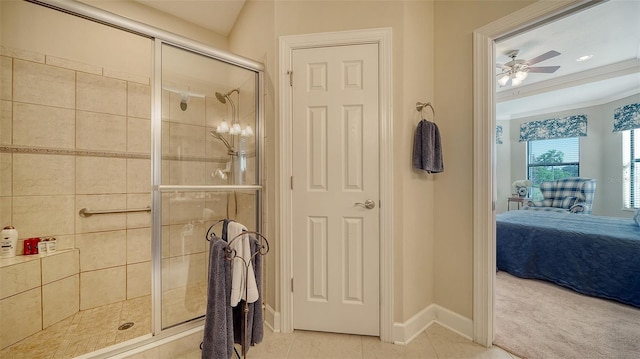 bathroom with tile patterned floors, ceiling fan, a shower with door, and crown molding