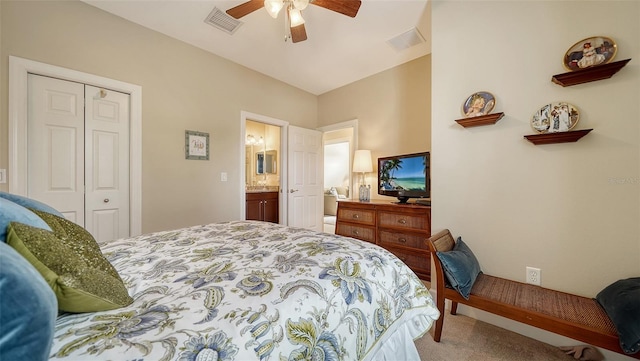 bedroom with carpet, ceiling fan, ensuite bathroom, and a closet