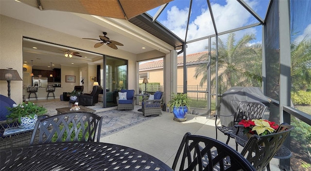 sunroom / solarium featuring ceiling fan