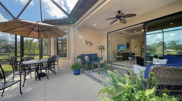 sunroom / solarium featuring ceiling fan