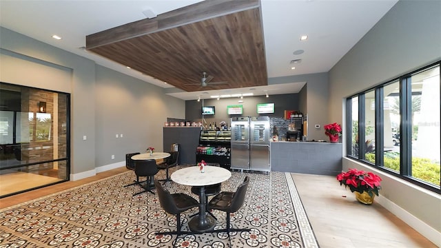 dining area with track lighting and ceiling fan