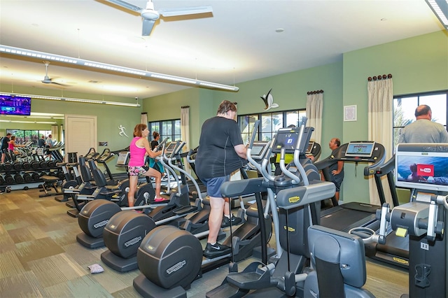 workout area with ceiling fan and light colored carpet