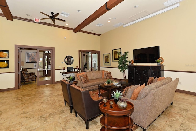 living room with french doors, ceiling fan, ornamental molding, and beam ceiling