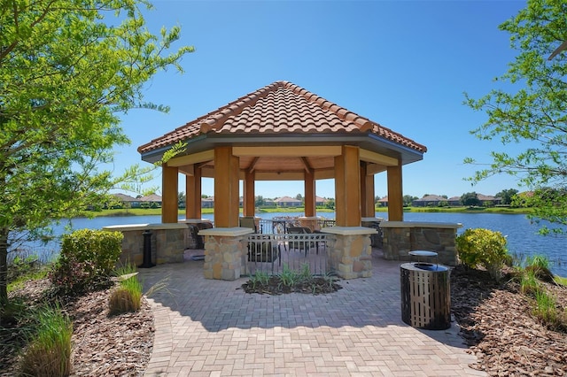 view of patio / terrace featuring a gazebo and a water view