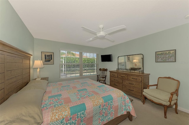 bedroom featuring ceiling fan and light carpet