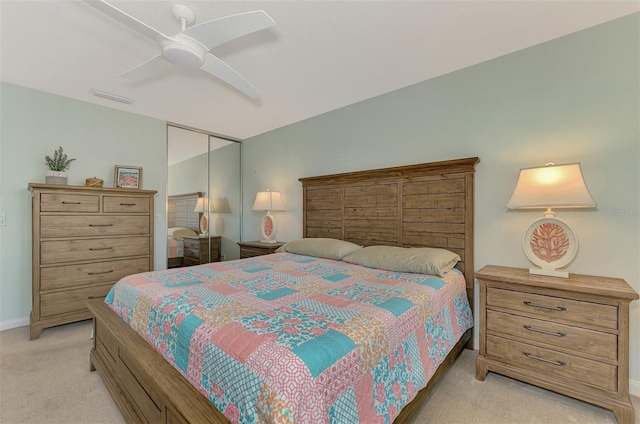 carpeted bedroom featuring ceiling fan and a closet