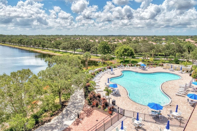 view of pool with a patio area and a water view